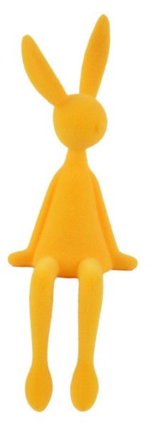 Gelber Kantenhocker Osterhase mit samtiger Beflockung sitzend auf einer Fensterbank